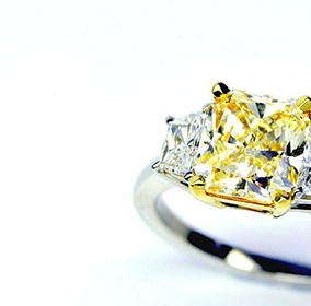 Trilogy ring with yellow cushion center diamond