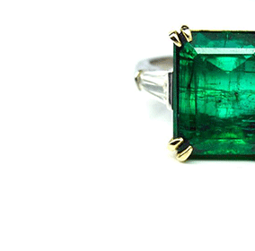 Emerald with step-cut diamond ring